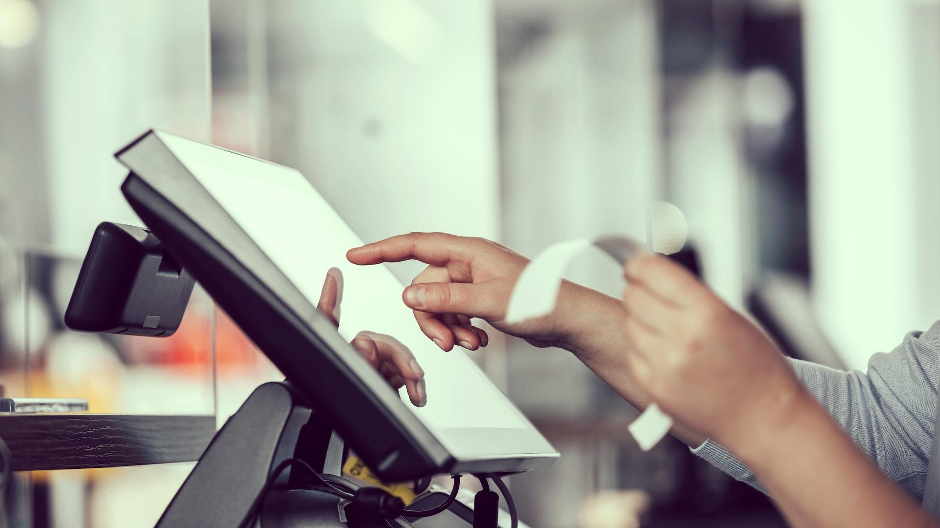 a person is using a pos machine in a store